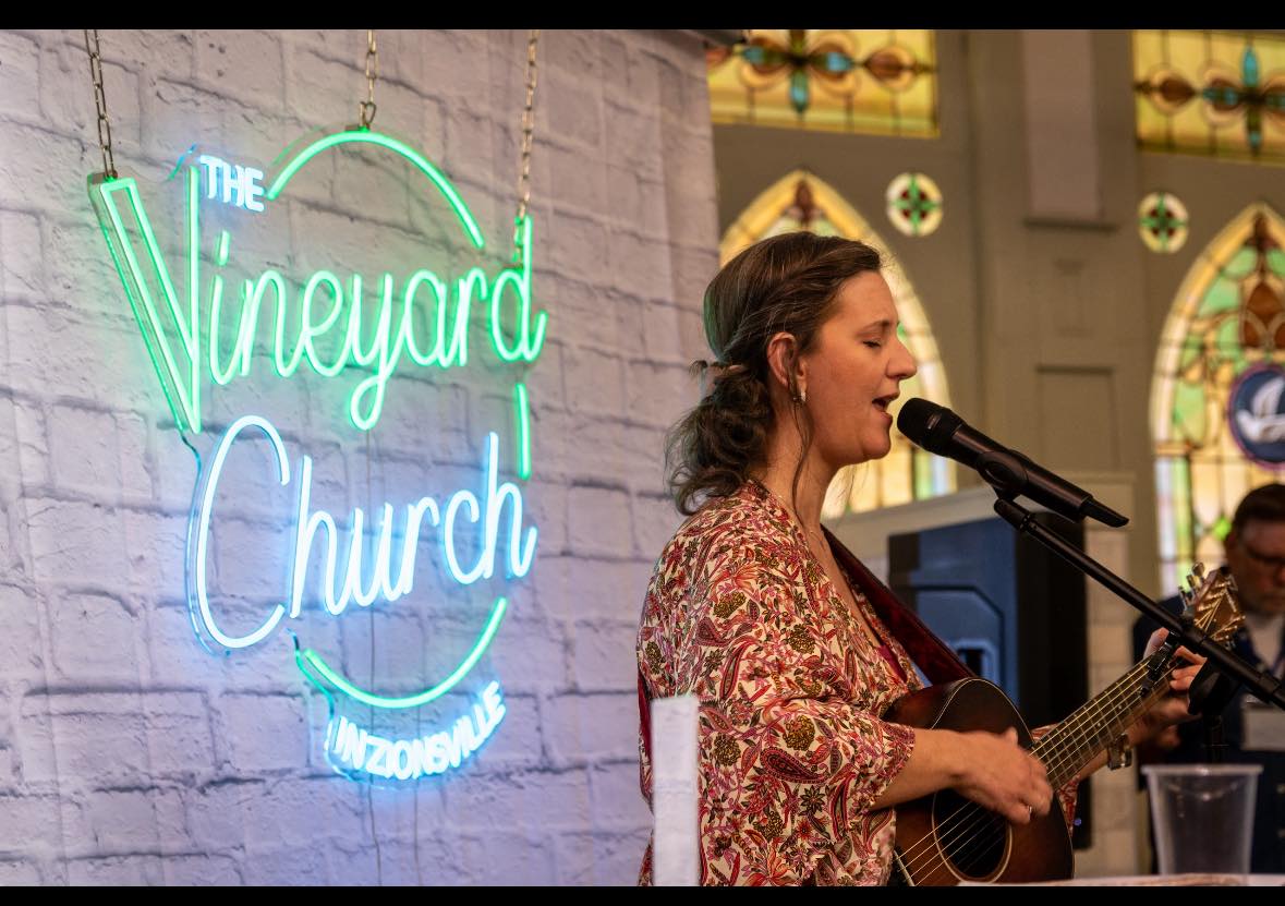 Worship leader singing at ViZi Church